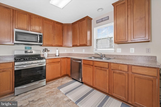 11 Gooseneck Ln, Smyrna, DE 19977 - kitchen with stainless steel appliances, a sink, light countertops, and brown cabinetry