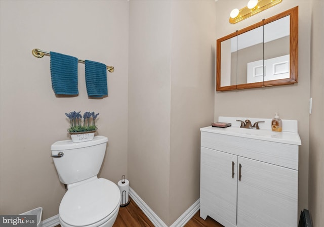 11 Gooseneck Ln, Smyrna, DE 19977 - bathroom featuring vanity, baseboards, wood finished floors, and toilet
