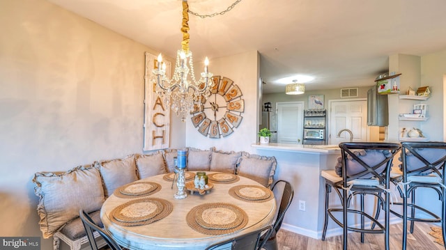 17 Bayside Dr, Somers Point, NJ 08244 - dining room with baseboards, a notable chandelier, wood finished floors, and visible vents
