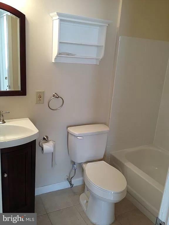 bathroom featuring tile patterned floors, vanity, toilet, and baseboards