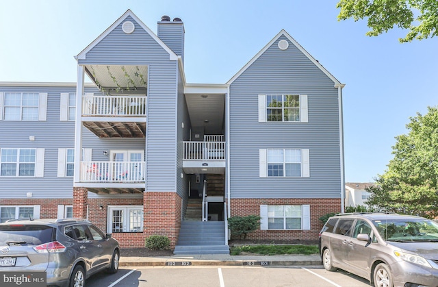 view of building exterior with uncovered parking