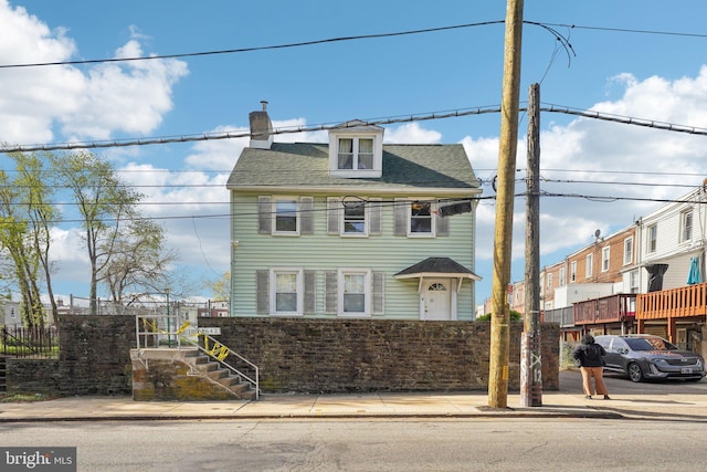 view of front of home featuring a chimney