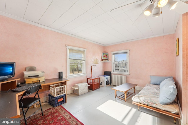home office with radiator heating unit, ornamental molding, and finished concrete flooring