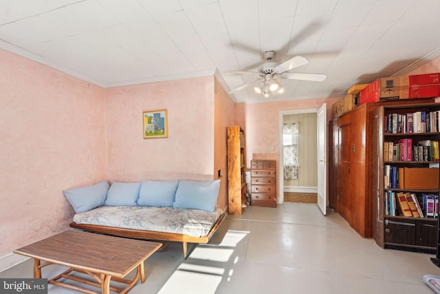 sitting room featuring ornamental molding and ceiling fan