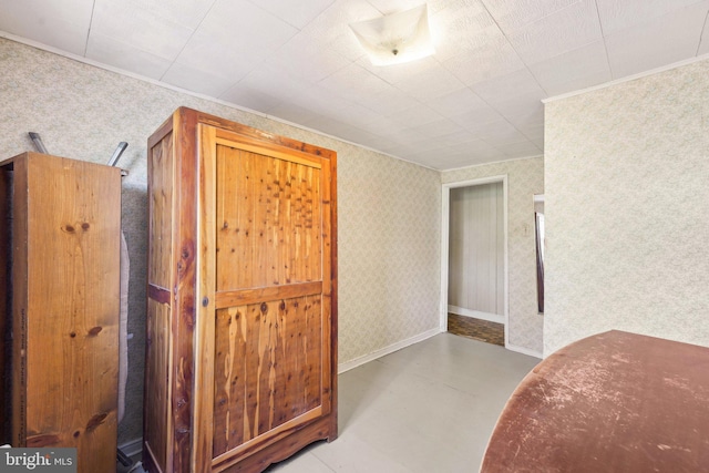 bedroom featuring crown molding and wallpapered walls
