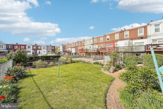 view of yard featuring fence and a residential view