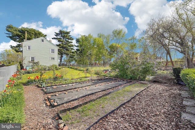 view of yard with fence and a garden