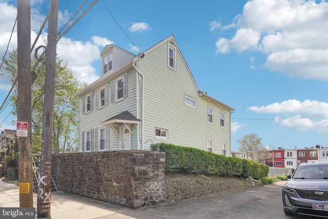 view of side of home featuring fence
