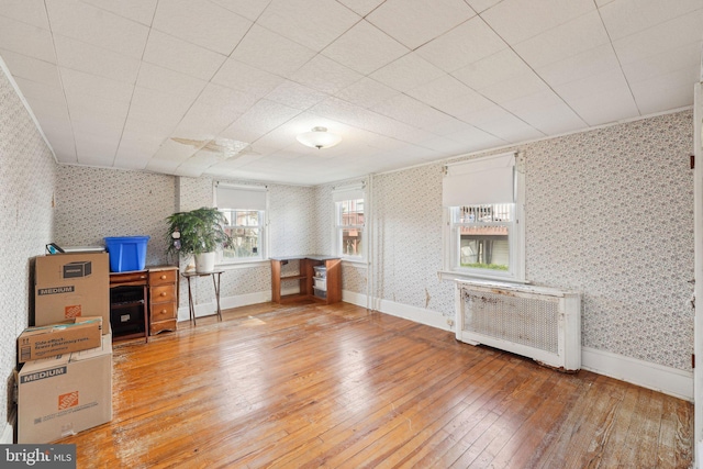 miscellaneous room featuring light wood-style floors, radiator, and wallpapered walls