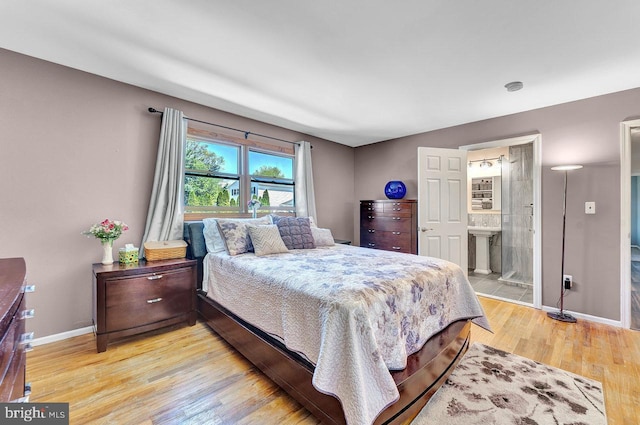 20 Wolfpack Rd, Hamilton, NJ 08619 - bedroom with a sink, baseboards, ensuite bathroom, and light wood-style flooring