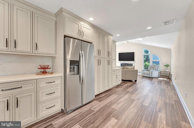 20 Wolfpack Rd, Hamilton, NJ 08619 - kitchen featuring visible vents, decorative backsplash, light wood-style flooring, and stainless steel fridge with ice dispenser