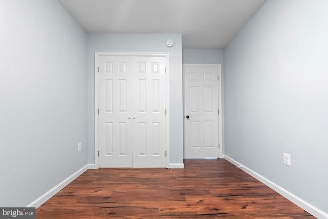 538 Pontiac, Baltimore, MD 21225 - unfurnished bedroom featuring dark wood-style flooring, baseboards, and a closet