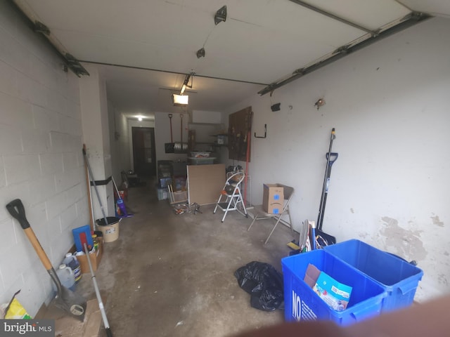 1512 Marcy Pl Unit B, Philadelphia, PA 19115 - garage featuring a garage door opener and concrete block wall