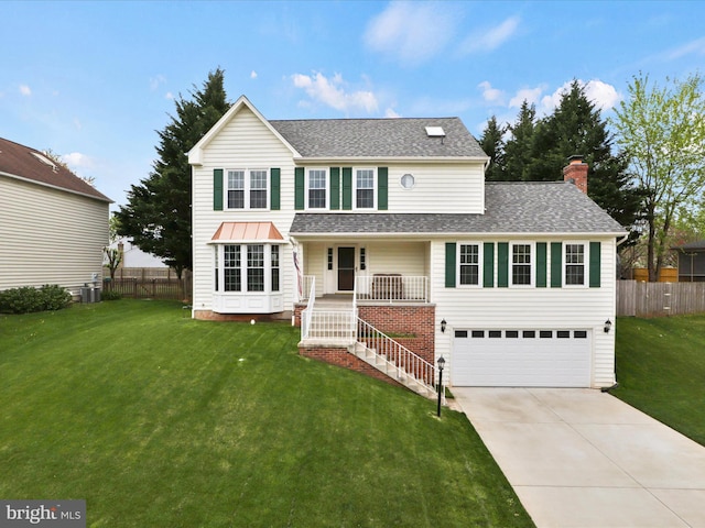 214 Primavera Cir, Sterling, VA 20165 - traditional-style house with fence, an attached garage, concrete driveway, and a front yard