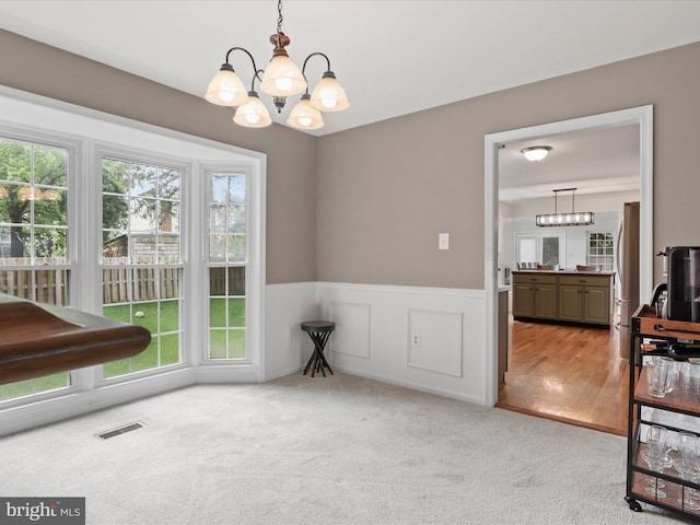 214 Primavera Cir, Sterling, VA 20165 - carpeted dining room featuring a notable chandelier, wainscoting, and visible vents