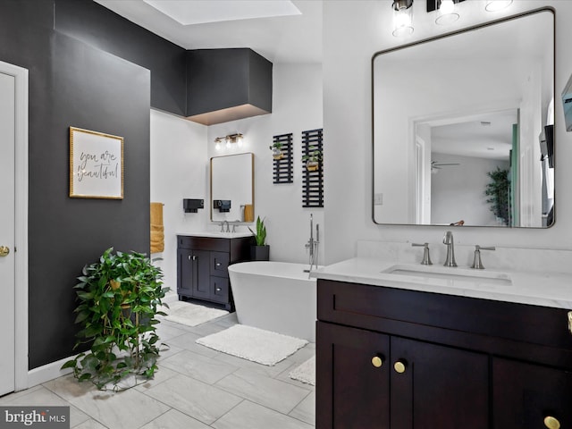 214 Primavera Cir, Sterling, VA 20165 - bathroom featuring ceiling fan, a sink, baseboards, a freestanding tub, and two vanities