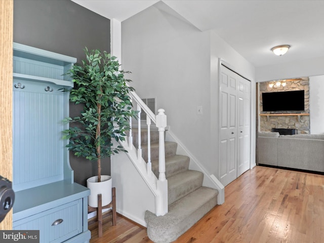 214 Primavera Cir, Sterling, VA 20165 - stairs featuring baseboards, wood finished floors, and a fireplace