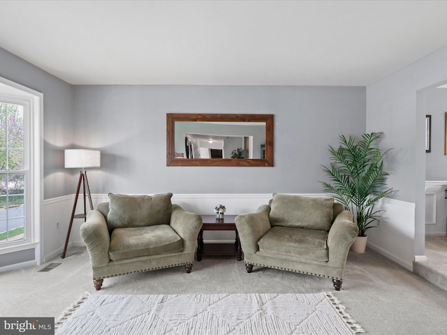 214 Primavera Cir, Sterling, VA 20165 - living area featuring carpet floors, visible vents, plenty of natural light, and a wainscoted wall