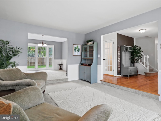 214 Primavera Cir, Sterling, VA 20165 - carpeted living area with a wainscoted wall, a chandelier, and stairway