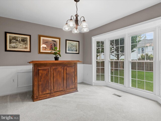 214 Primavera Cir, Sterling, VA 20165 - dining space featuring light colored carpet, visible vents, a chandelier, and a wainscoted wall