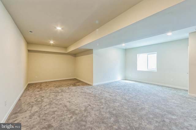 below grade area featuring carpet floors, recessed lighting, baseboards, and visible vents