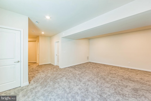 below grade area with carpet floors, baseboards, recessed lighting, and visible vents