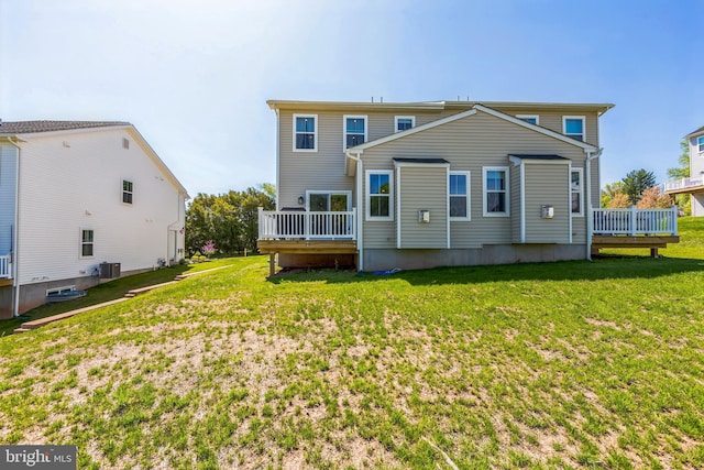 rear view of property with a wooden deck, a yard, and central AC unit