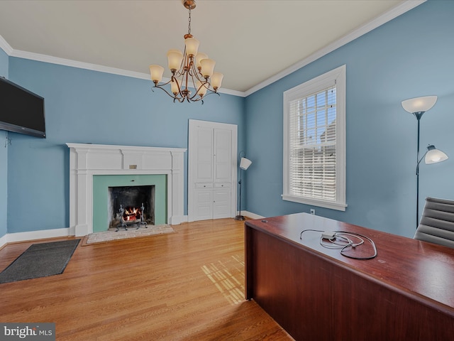 203 S George St, Charles Town, WV 25414 - home office with wood finished floors, baseboards, a notable chandelier, a lit fireplace, and crown molding