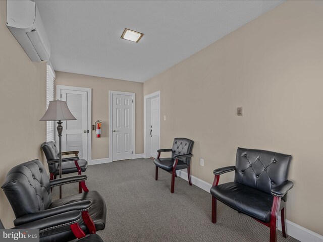 203 S George St, Charles Town, WV 25414 - sitting room featuring baseboards, a wall mounted air conditioner, and carpet