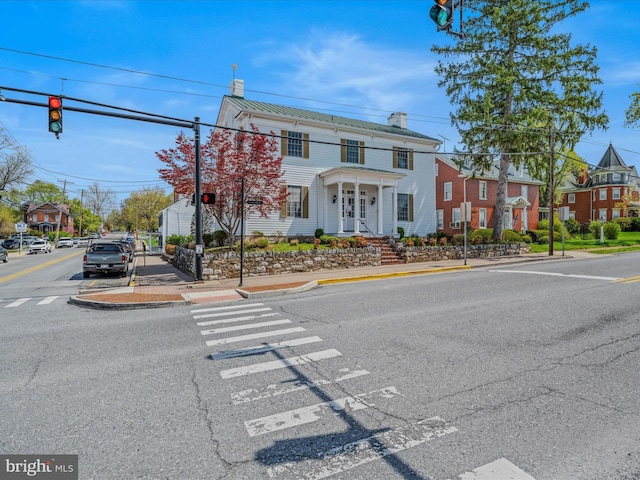 203 S George St, Charles Town, WV 25414 - italianate-style house with a chimney, a standing seam roof, a residential view, and metal roof