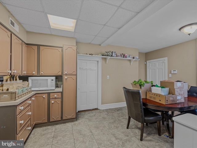 203 S George St, Charles Town, WV 25414 - dining room with light tile patterned floors, a paneled ceiling, visible vents, and baseboards
