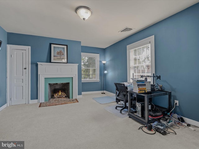 203 S George St, Charles Town, WV 25414 - office area featuring baseboards, visible vents, carpet floors, and a fireplace with flush hearth