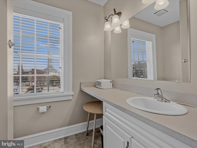 203 S George St, Charles Town, WV 25414 - bathroom featuring visible vents, vanity, and baseboards