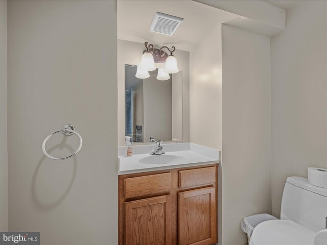 203 S George St, Charles Town, WV 25414 - bathroom with visible vents, toilet, and vanity