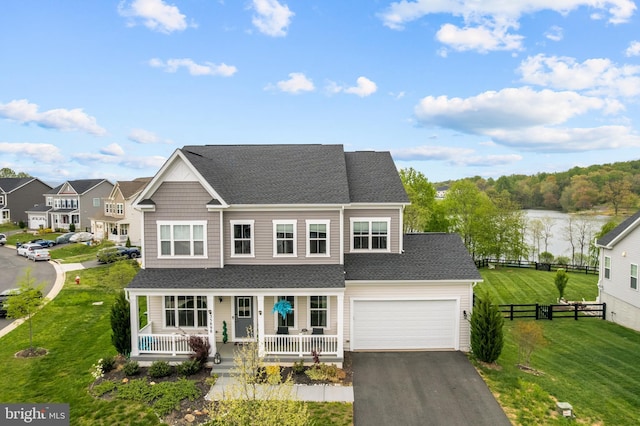 35898 Quantum Pl, Round Hill, VA 20141 - view of front of house with a porch, a shingled roof, asphalt driveway, an attached garage, and a residential view