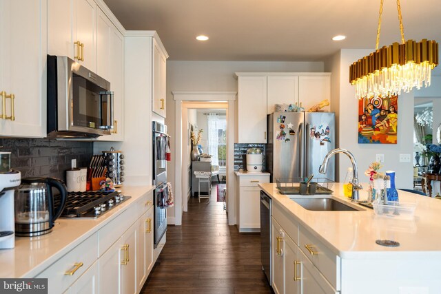 35898 Quantum Pl, Round Hill, VA 20141 - kitchen with appliances with stainless steel finishes, a sink, light countertops, backsplash, and white cabinetry