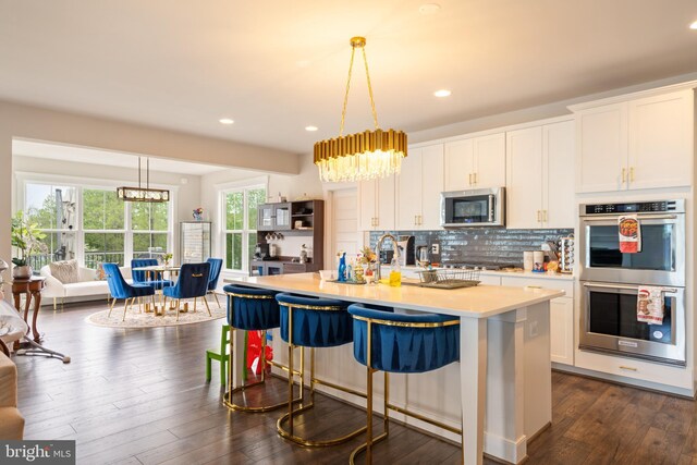 35898 Quantum Pl, Round Hill, VA 20141 - kitchen with appliances with stainless steel finishes, a chandelier, light countertops, white cabinetry, and recessed lighting