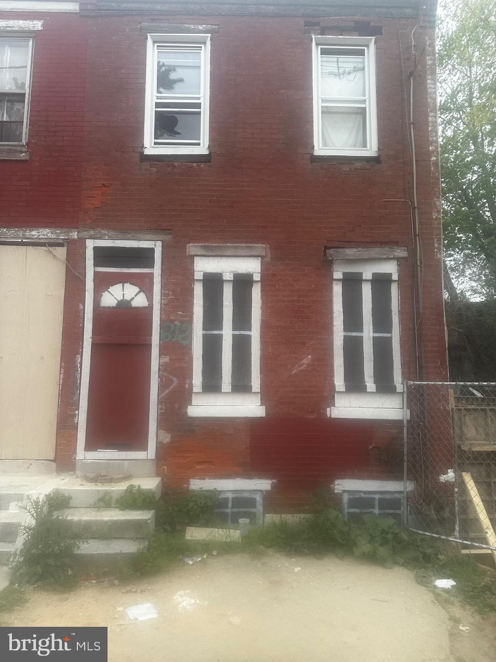 exterior space with fence, entry steps, and brick siding