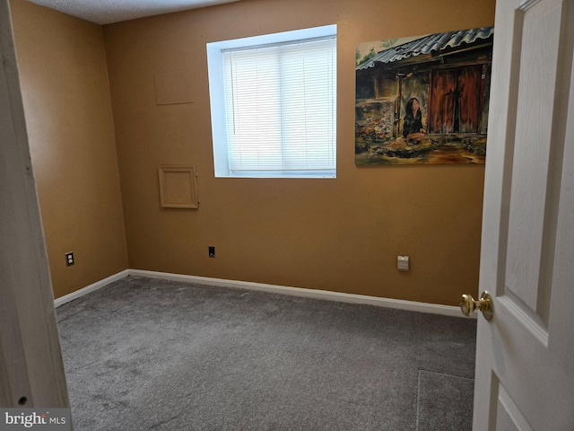 unfurnished bedroom with baseboards and carpet