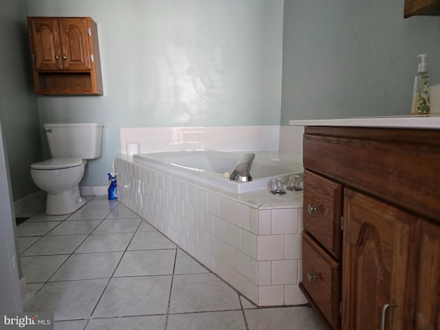 full bathroom featuring toilet, a bath, tile patterned flooring, and vanity