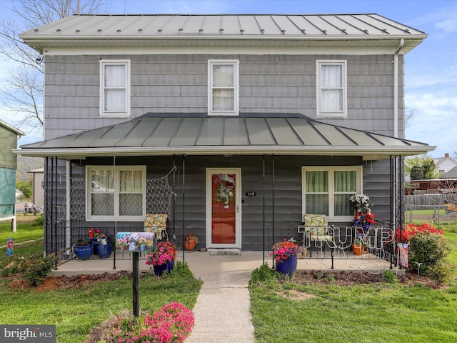 view of front of home with covered porch, a standing seam roof, and metal roof