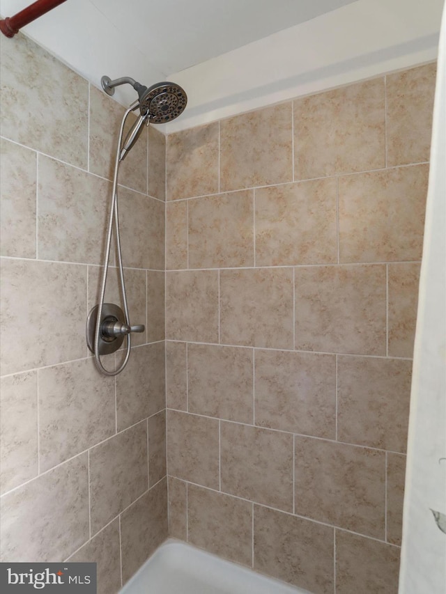 full bathroom with tiled shower