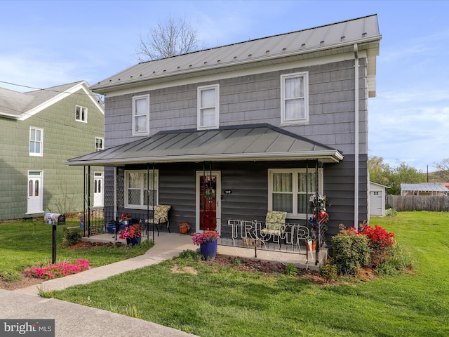back of property with a porch, metal roof, and a standing seam roof