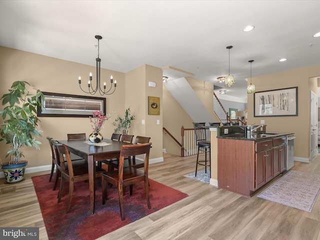 dining area with baseboards, stairway, light wood-type flooring, recessed lighting, and a notable chandelier