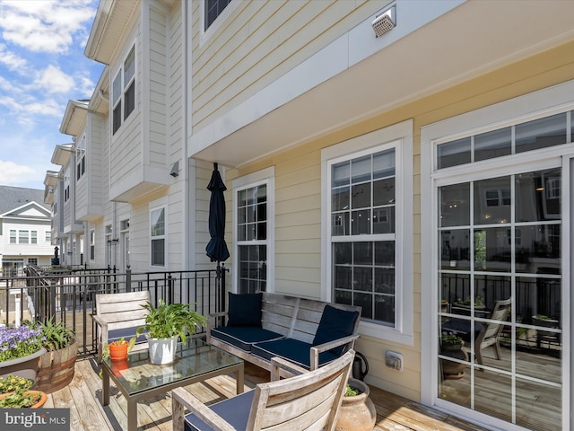exterior space with an outdoor hangout area and a wooden deck