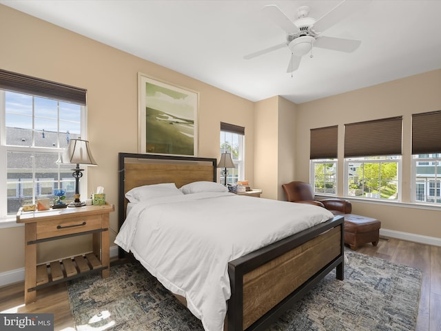 bedroom featuring baseboards, a ceiling fan, and wood finished floors