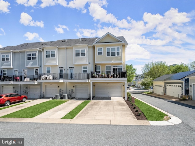 view of front facade featuring a residential view, driveway, and a garage