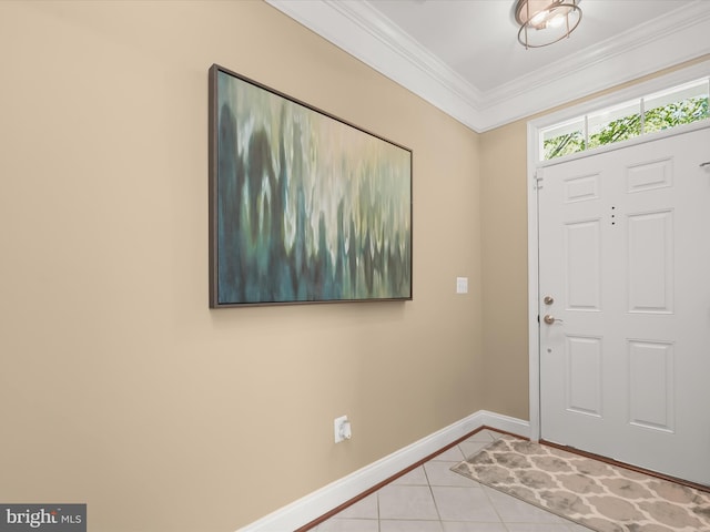 tiled foyer entrance featuring crown molding and baseboards