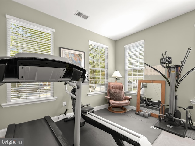 workout room featuring baseboards and visible vents