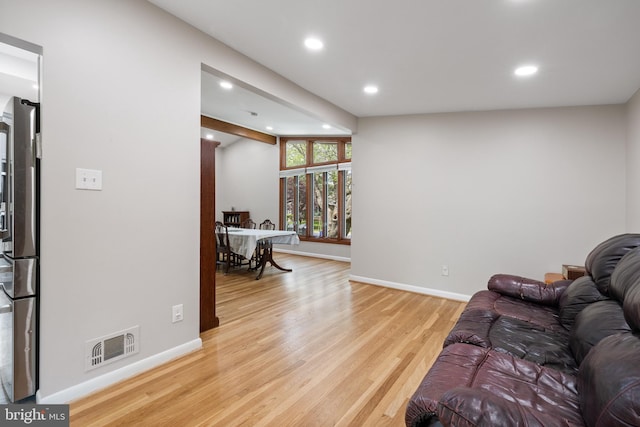 living area with light wood finished floors, recessed lighting, and baseboards